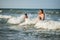 Cheerful young mother swims in the sea