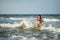 Cheerful young mother swims in the sea