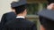 Cheerful young people in academic gowns and caps ready for graduation ceremony