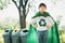 Cheerful young superhero boy with cape and recycle symbol. Gyre