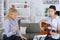 Cheerful young teen musician playing guitar