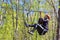 Cheerful young tourist girl descends on Zipline