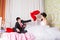 Cheerful young wedding couple pillow fighting in bed at home