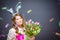 Cheerful young woman with bunny ears and Easter egg basket and tulips Flowers Looking at camera