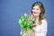 Cheerful young woman with bunny ears and Easter egg basket and tulips Flowers Looking at camera