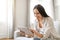 Cheerful young woman engaged with her digital tablet at home