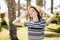 Cheerful young woman in hat and sunglasses in summer palms backgrounds. Summer vocation.