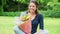 Cheerful young woman smelling flowers