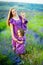 Cheerful young woman with two young girls on the background of beautiful nature in spring