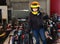 Cheerful young woman in yellow helmet at kart circuit