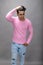 Cheerfull young male model in casual wear wearing pink t-shirt and blue denim jeans. Fitness model. Advertisement shot