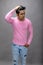 Cheerfull young male model in casual wear wearing pink t-shirt and blue denim jeans. Fitness model. Advertisement shot