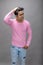 Cheerfull young male model in casual wear wearing pink t-shirt and blue denim jeans. Fitness model. Advertisement shot
