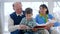 Cheerfulness pensioner family, grandparents with baby learn to read kid