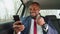 Cheering black businessman with phone celebrating success in car