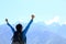 Cheering hiking woman enjoy the beautiful view at mountain peak in tibet,china