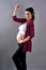 A cheering pregnant woman with hands on her belly