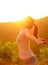 Cheering woman hiker raised arms mountain top