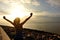 Cheering woman open arms on beach