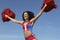 Cheerleader Cheering With Arms Raised While Holding Pompom