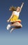 Cheerleader Jumping Midair Against Clear sky