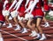 Cheerleaders cheering for football fans during a high school game