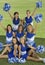 Cheerleaders Holding Pompoms On Field