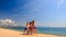 cheerleaders in uniform group do Toe Touch Basket Toss on beach