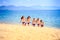 Cheerleaders in white blue steps out of sea smiles on beach