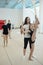 Cheerleading teacher supporting girl doing vertical standing split