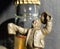 Cheers! - Metall figure of the man with a beer stein in a hand, bottle in blur on a background