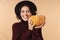 Cheery brunette woman holding pumpkin