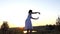 Cheery Woman Does Waving Movements With Her Hands at a Splendid Sunset in Slo-Mo