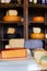 Cheese assortment. Coloured gouda and parmesan cheese at grocery shop background