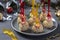 Cheese balls with crab sticks and shrimps - festive snack for Christmas and New Year on gray. Closeup