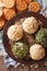 Cheese balls with crackers, herbs and seeds close-up. vertical t