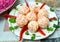 cheese balls made out of crab sticks on a plate, decorated with red pepper