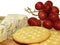 cheese and biscuits with a bunch of grapes