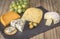 Cheese board with four cheeses, gouda with pimento, gouda with c