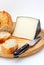 Cheese, bread and knife on wood plate