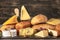 Cheese and bread. many types of bread and cheese on wooden rustic background. cheese platter, tasting and pairing. An assortment