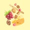 Cheese, breadstick, grapes and walnuts falling against pale light yellow background