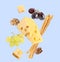 Cheese, breadsticks, grapes and walnuts falling against pale light blue background