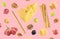 Cheese, breadsticks, grapes and walnuts falling against pale pink background