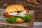 Cheese Burger Closeup of home made beef burgers with lettuce served on little wooden cutting board.