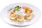 Cheese cakes with sour cream, slices of sweet peach, mint and red currants on a white plate. Clipping path