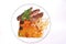 Cheese casserole with slises of grilled meat on white background on a transparent plate, close up