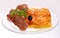 Cheese casserole with slises of grilled meat on white background on a transparent plate, close up