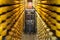 Cheese cellar alley full of Le Gruyere AOP Swiss cheese wheels and JNJ automation maturing robot at La Maison du Gruyere in