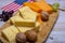 Cheese collection, blocks and slices of yellow and matured american cheddar cheese and Californian walnuts with flag of USA